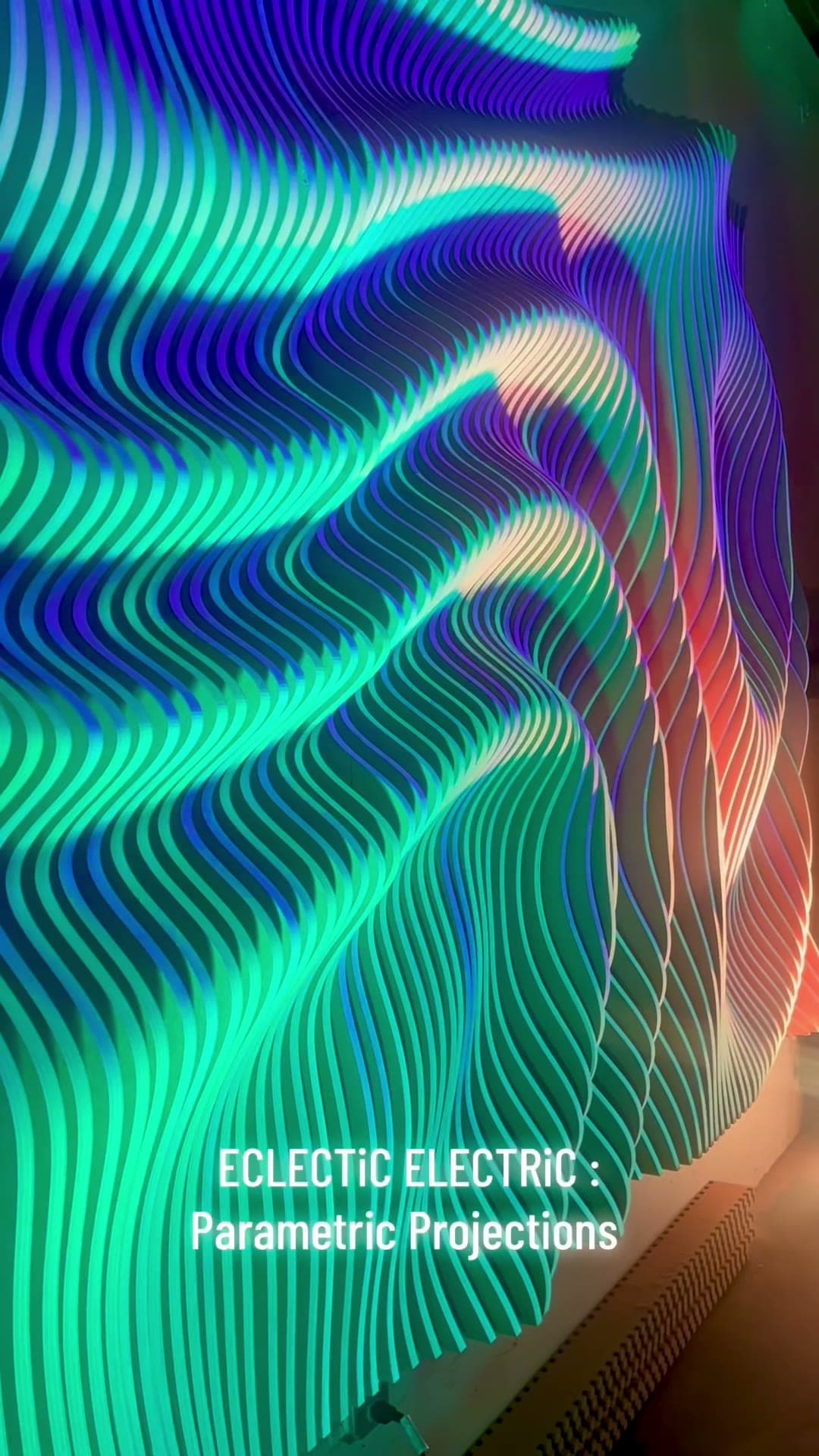 Iridescent parametric projection flowing across a contoured rib wall
