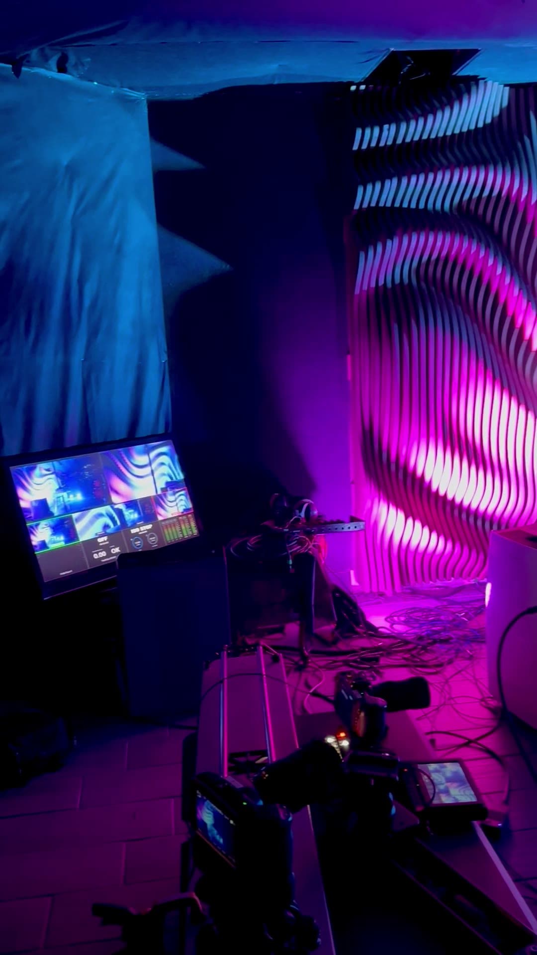 Projection-mapped rib wall install in the studio with cameras and monitors
