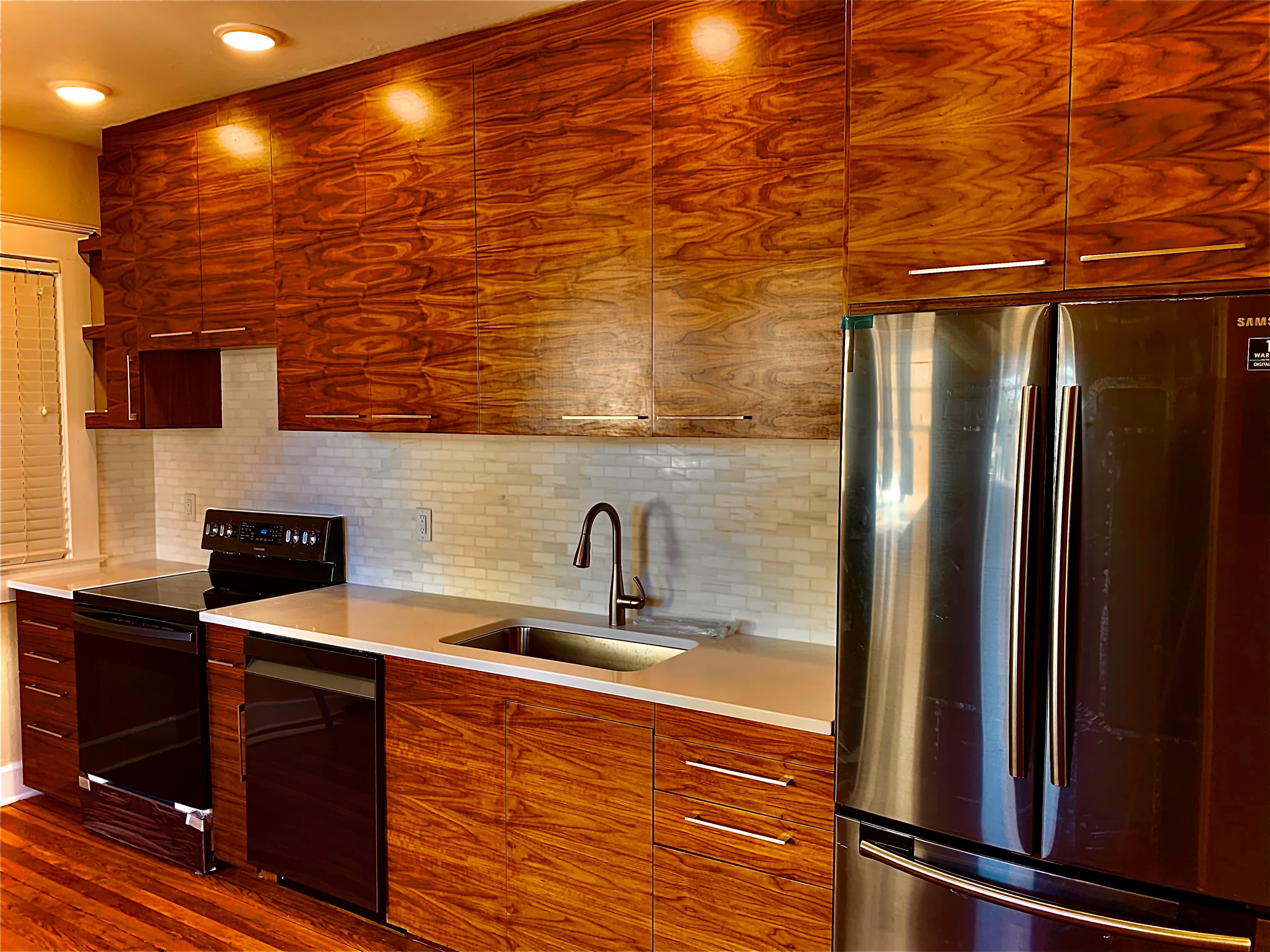 Custom wood slab-front kitchen cabinetry with stainless appliances, Gainesville FL