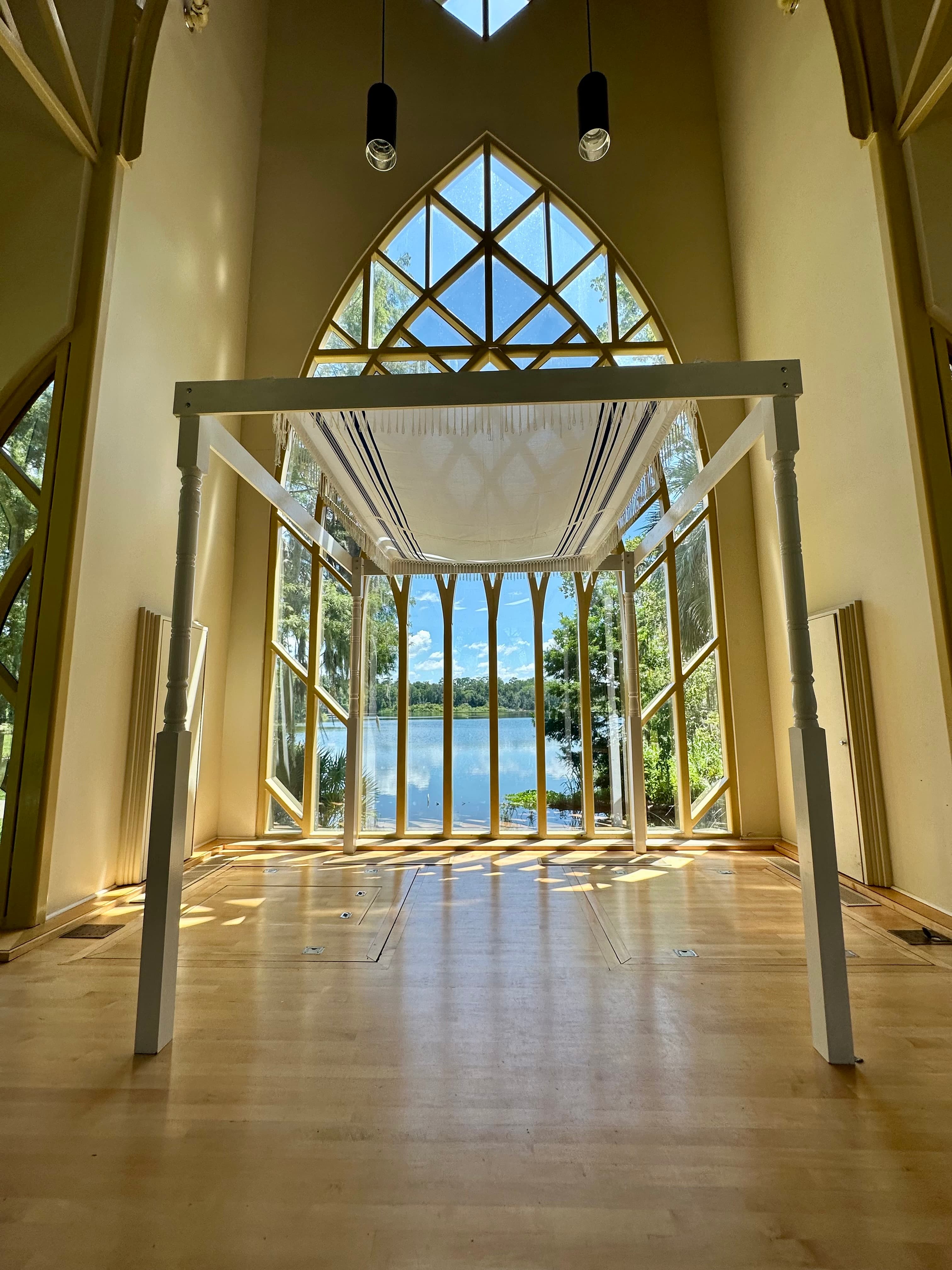 Curved timber arches and dimensional paneling inside the Baughman chapel