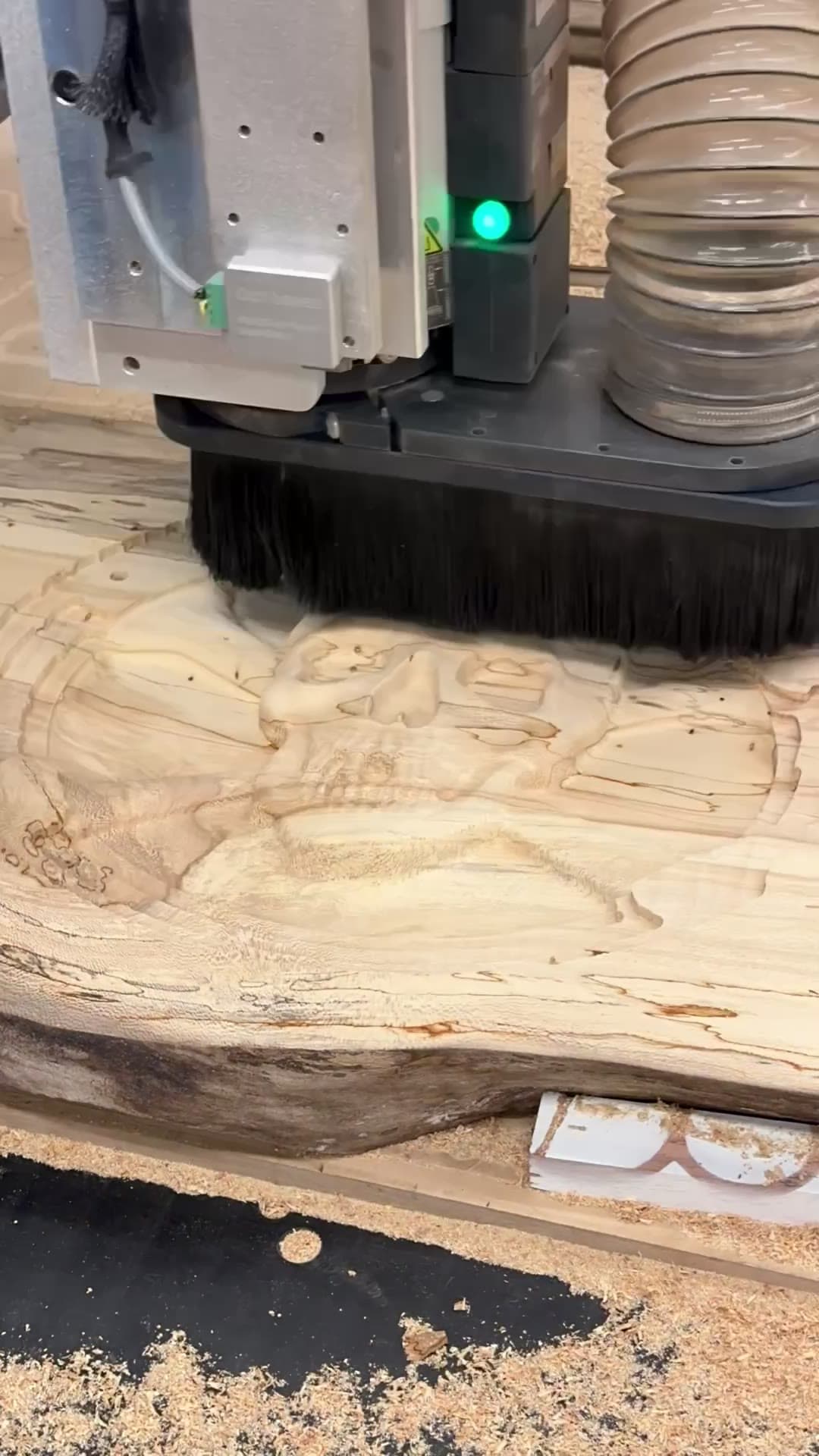 The CNC carving a hardwood panel for a record-storage divider