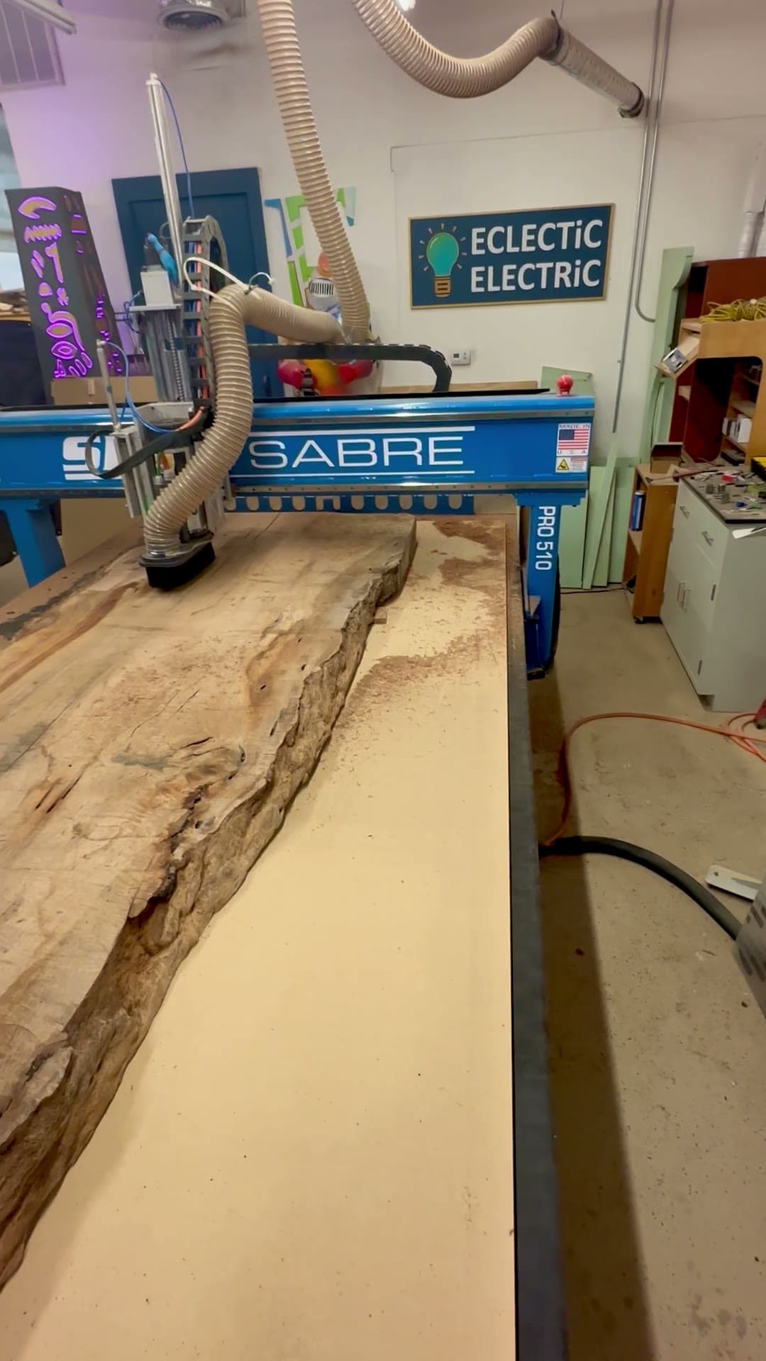 The ShopSabre 510 Pro taking a surfacing pass across a live-edge hardwood slab