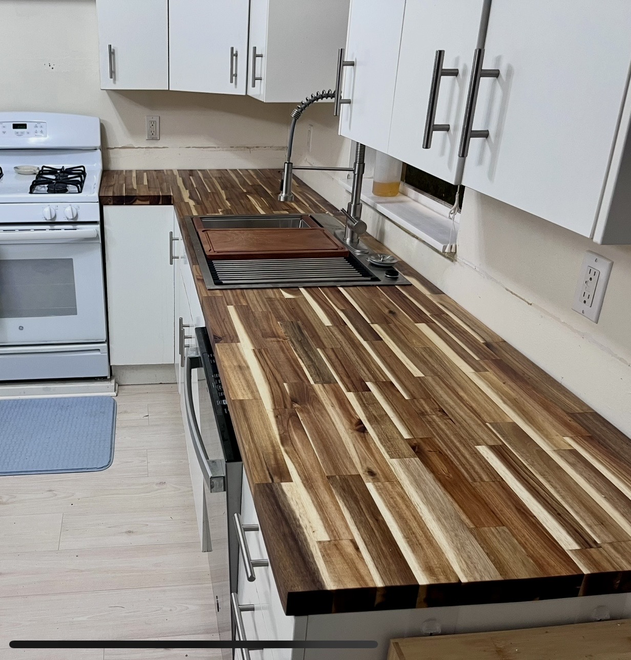 Butcher-block countertop install over white cabinets